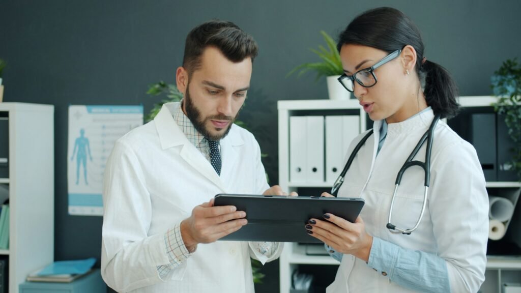 Healthcare professionals reviewing information on a tablet